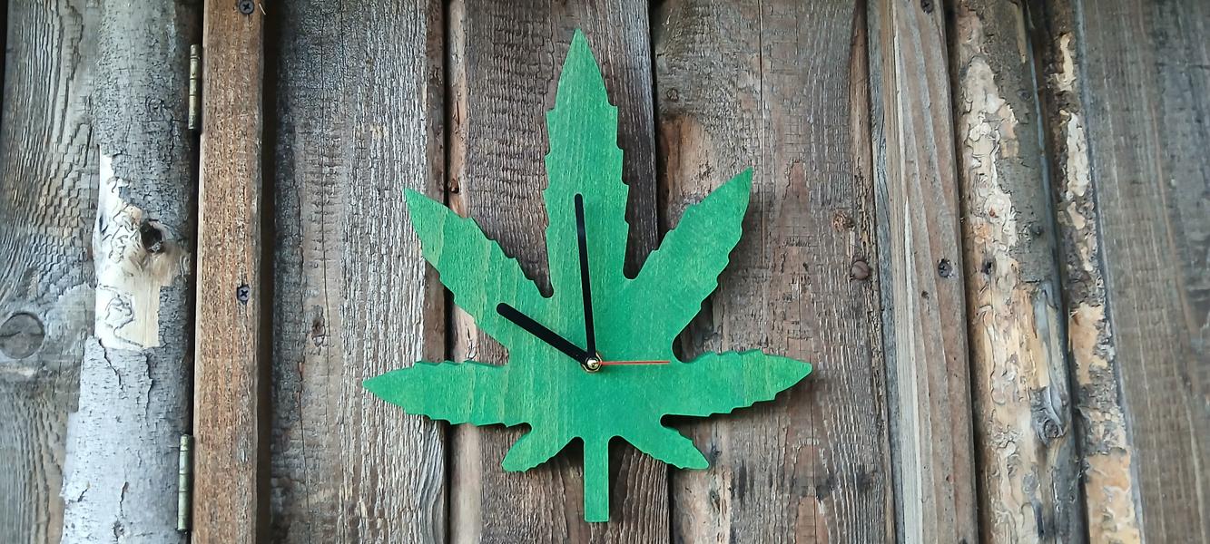 Cannabisblatt-Wanduhr aus Holz mit drei Blättern in Grün und Naturfarben