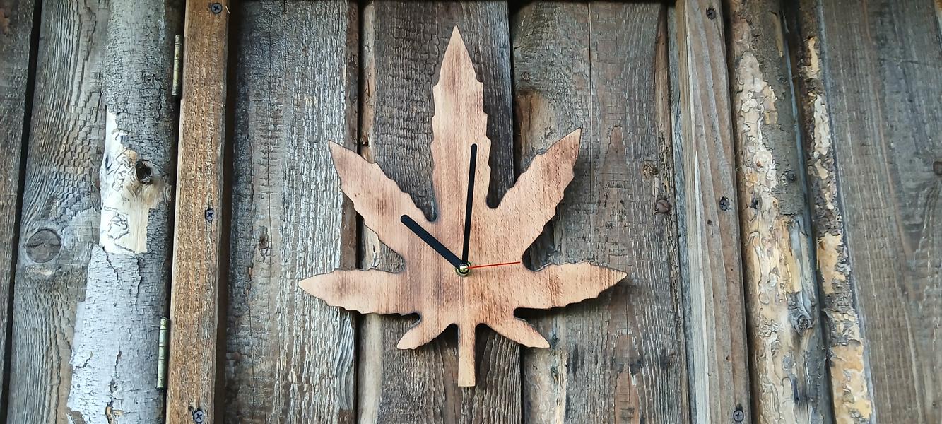 Cannabisblatt-Wanduhr aus Holz mit drei Blättern in Grün und Naturfarben